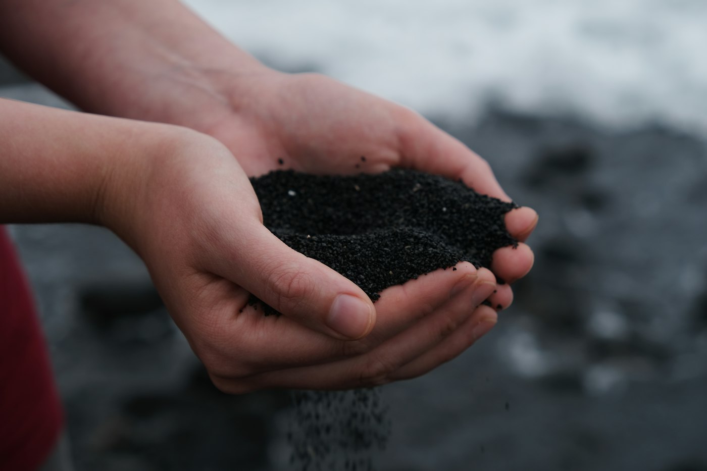 Hands holding rich compost